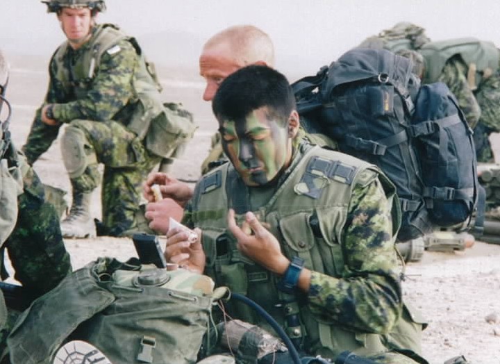 Canadian soldiers apply cam-cream in Afghanistan